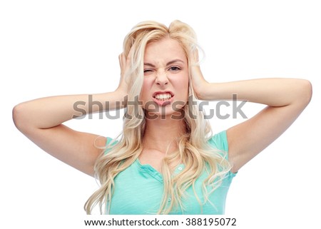 emotions, expressions, hairstyle and people concept - young woman holding to her head and screaming