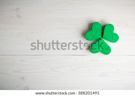 Green shamrock clovers on white wooden background . Background for St. Patrick's Day celebration