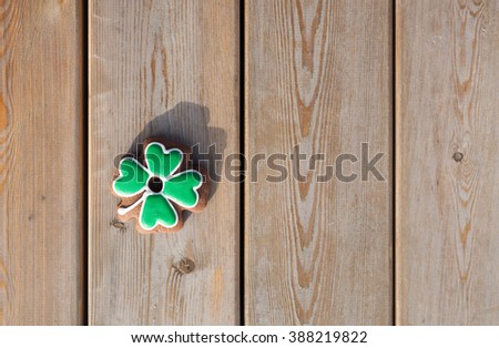 Happy St Patrick's Day decor. Gingerbread cookie baked in shape of a shamrock leaft for Saint Patricks Day celebration