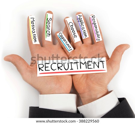 Photo of hands holding paper cards with RECRUITMENT concept words