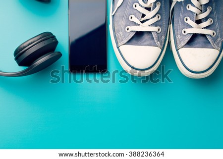 headphones, smart phone and sneakers on colorful background