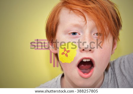 redhead fan boy with new mexico state flag painted on his face.