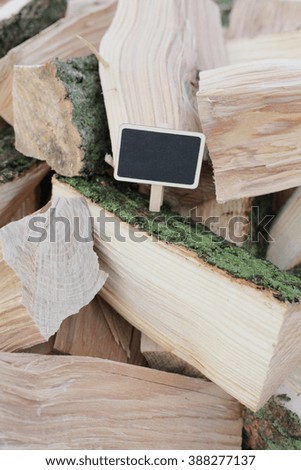 Firewood with black chalkboard. Wooden background. Shabby background. many wooden pieces. Save the planet. 