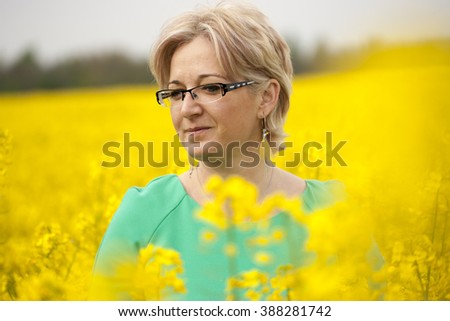 Forty years old woman in rape field at spring