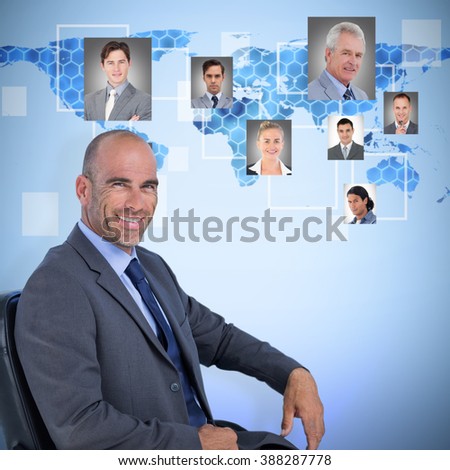 Portrait of confident businessman sitting on chair against background with hexagons and world map