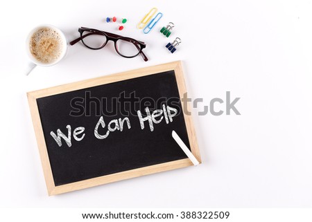 We Can Help word on chalkboard with coffee cup and eyeglasses, view from above