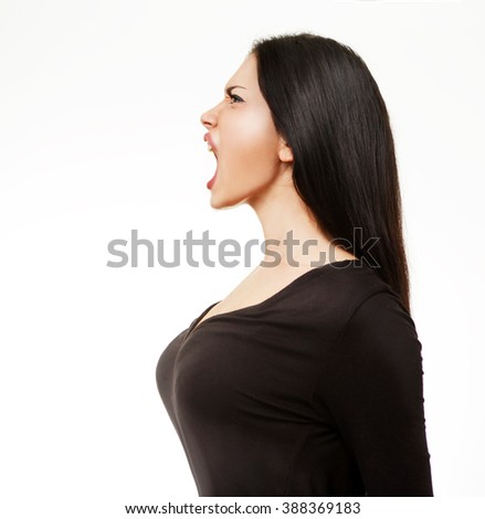 Angry young woman screaming Royalty-Free Stock Photo #388369183