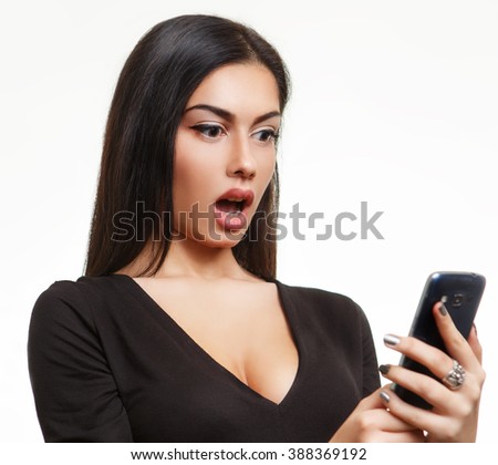 Shocked woman looking at phone Royalty-Free Stock Photo #388369192