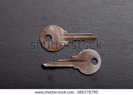 Old metal keys on black background. Top view.