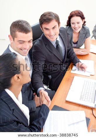 Young businessman and businesswoman in a meeting shaking hands