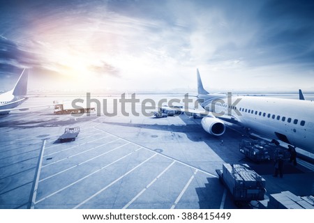 Airport with many airplanes at beautiful sunset Royalty-Free Stock Photo #388415449