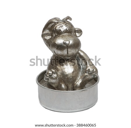 Isolated silver monkey candle over white background close-up