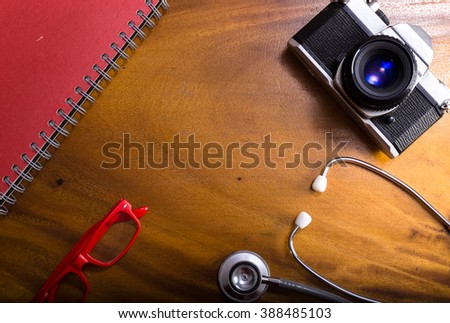 Stethoscope with camera and glasses. Stethoscope, on wooden background