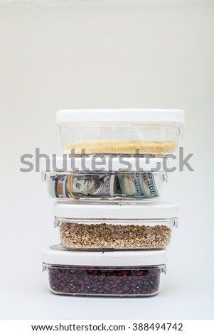 Money saving for a rainy day. Dollars in plastic containers isolated on white