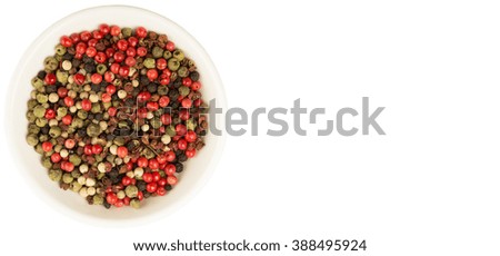 Mix peppercorn variety in white bowl over white background