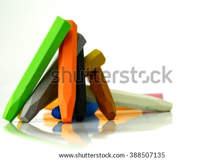 multicolor crayon pencils set like as bonfire ( light green , orange , grey , yellow , blue , white ) on isolated-white background Royalty-Free Stock Photo #388507135