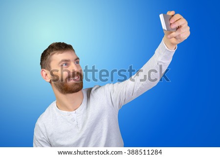 Cheerful young man making photo of himself 
