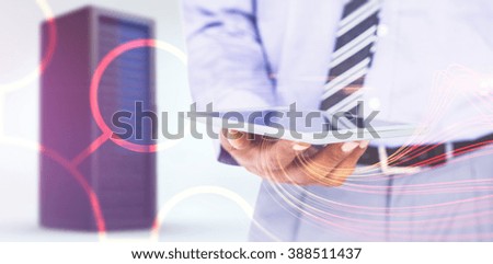 Close up view of businessman using tablet computer against black background with shiny lines