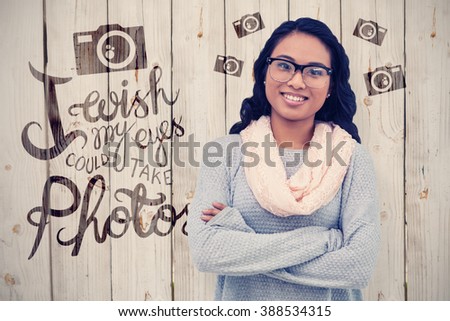 Asian woman with arms crossed against wooden background