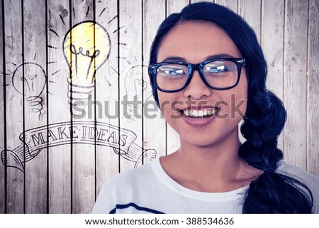 Smiling Asian woman looking at the camera against wooden planks