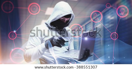 Hacker using laptop to steal identity against abstract glowing black background Royalty-Free Stock Photo #388551307