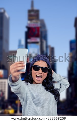 Asian woman taking selfie against new york street