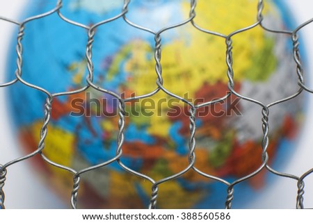 the global map behind a wire fence