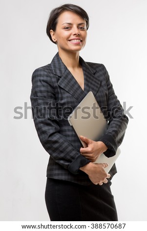 Young attractive business woman in a studio with a laptop