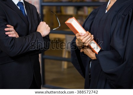 Close up of lawyer holding a law book in office