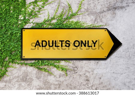 Adults only on yellow sign hanging on ivy wall