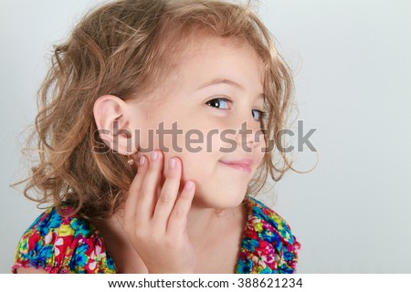 beautiful girl with earring Royalty-Free Stock Photo #388621234