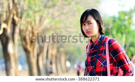 Woman portrait in the park with her posture, feeling and vintage costume. Images aim to be retro