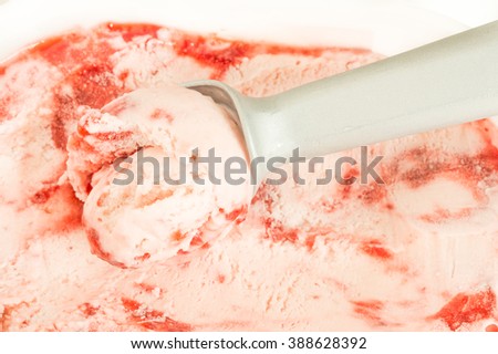 Strawberry icecream with straberry jam and scoop, selective focus