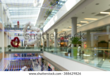 A blurred bright bright large room with several floors of a shopping mall in major city. Lobby mall with many shops, supermarkets and restaurants waiting for customers. Scenery in the mall. Copy space