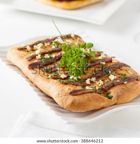 Catalan food. Coca with anchovies. Coca is a typical pastry from the Catalan region of Spain. Similar preparations can be found in other Mediterranean countries.