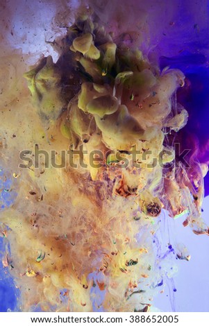 Colorful abstract artistic texture. Liquids in dynamic flow mixing. Complementary colors. Cold versus hot feeling. Distant Blue background and yellow hue tones up front. Pieces of solids falling.