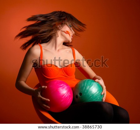 young woman holding bowling balls