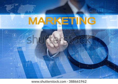 Businessman hand touching MARKETING button on virtual screen