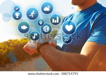 Exercising Man Checking Activity Tracker With Health Icons Royalty-Free Stock Photo #388714795