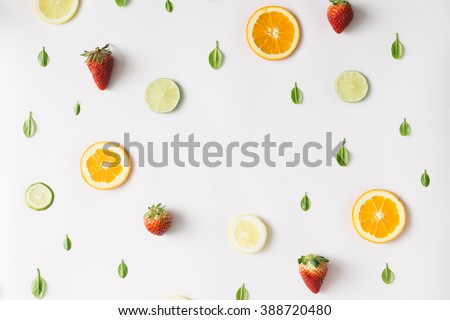 Colorful pattern made of citrus fruits, leaves and strawberries