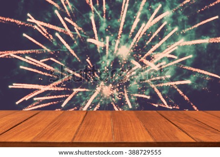 Wood table top on blur firework background. can used for display or montage your products