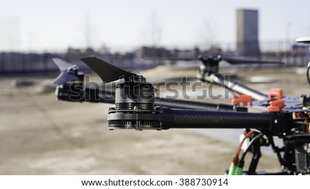 Drone close up in a urban setting. Image shows details of a multi rotor drone with an urban. background 