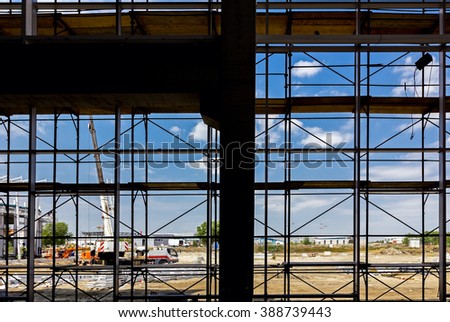 Silhouette of empty scaffolding in the construction site with back light from outside.