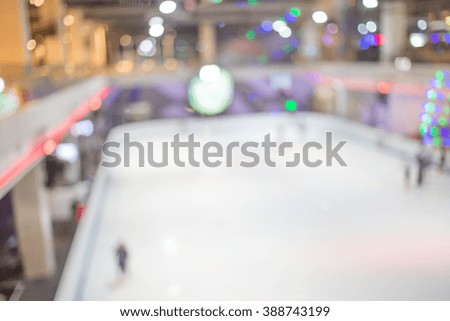 Blurred  people skating on the ice rink.