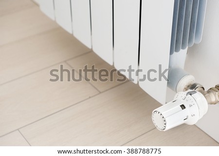 White radiator in an apartment. Radiator. Royalty-Free Stock Photo #388788775