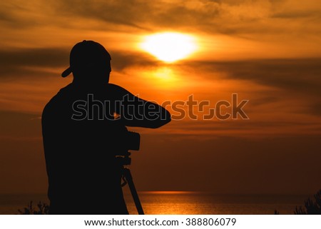 silhouette of photographer catching the sunset