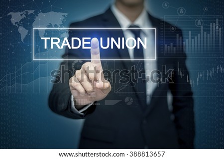 Businessman hand touching TRADE UNION  button on virtual screen Royalty-Free Stock Photo #388813657