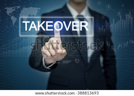 Businessman hand touching TAKEOVER  button on virtual screen Royalty-Free Stock Photo #388813693
