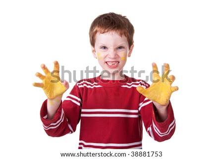 Photo of an adorable child playing with yellow paint.