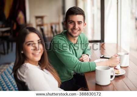 Portrait of a handsome young man having a good time with his girlfriend in a coffee shop